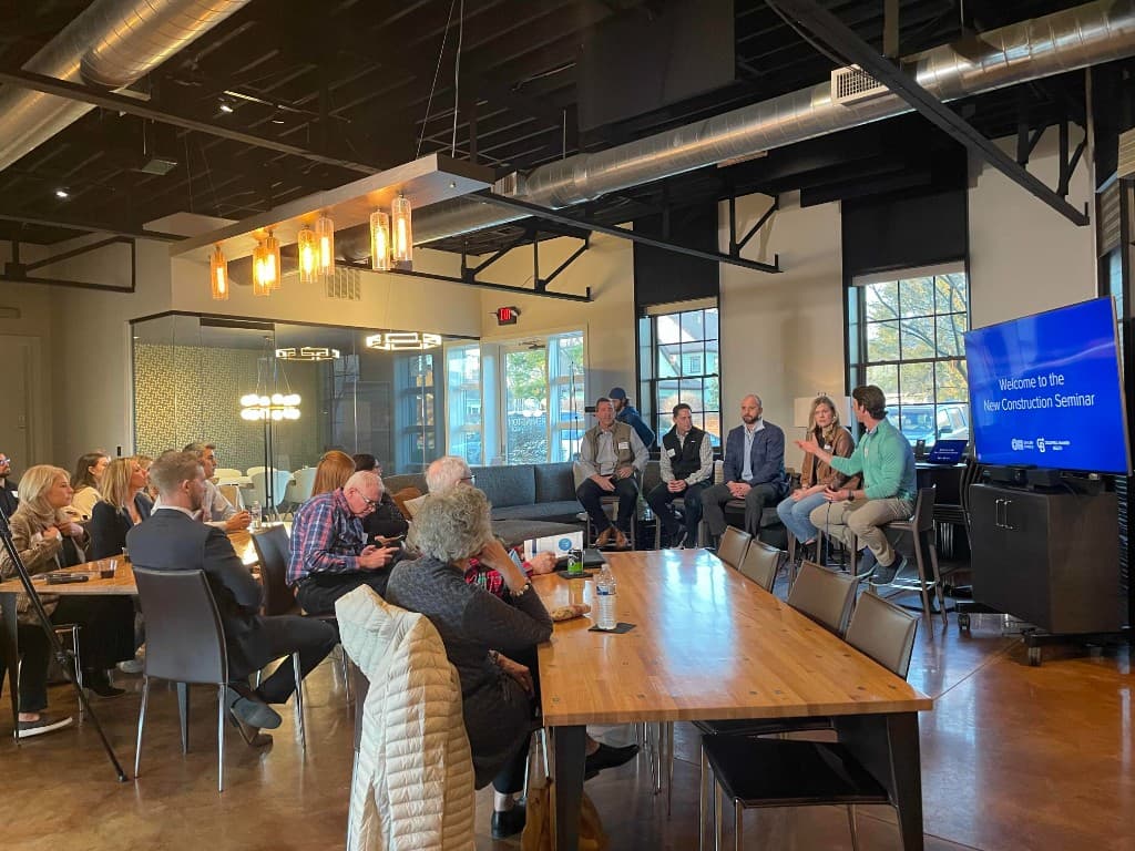 A panel presenting to guests at a business seminar in The Remington Room