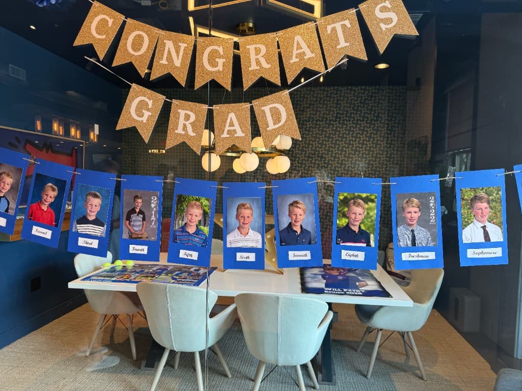 Congrats Grad photo timeline hanging in the conference room