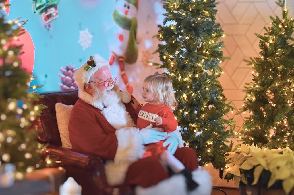 Santa visiting with a child at a holiday gathering in The Remington Room