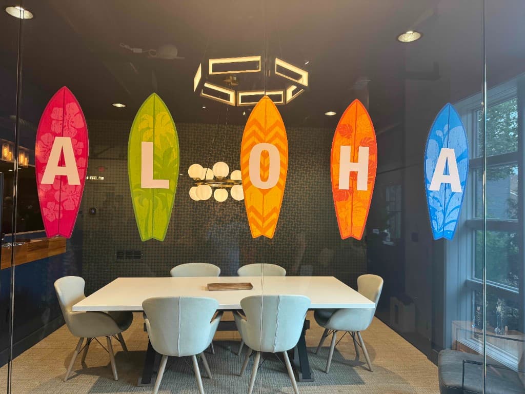 Conference room through glass with colorful Aloha surfboard decals