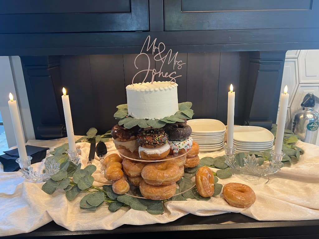 Wedding cake and donut tower topped with a Mr & Mrs Jones sign